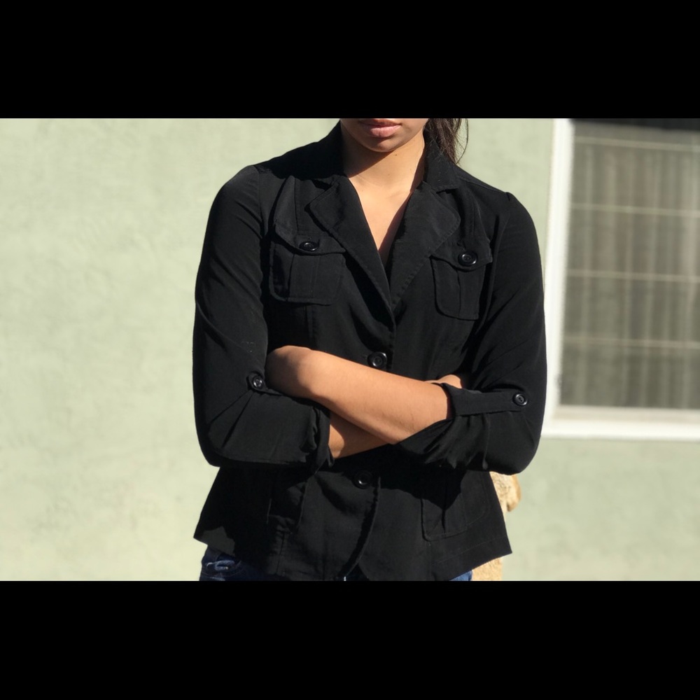 Black, long sleeved, v neck blouse.